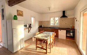 A compact kitchen with a refrigerator, microwave, sink, and stove. - Stunning home in Sampzon (Sampzon)