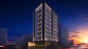 A modern high-rise hotel with multiple floors, illuminated windows, and a prominent entrance. - Minn Hakata Station East (Fukuoka)
