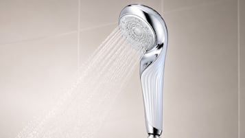 A modern showerhead with water flowing from it.