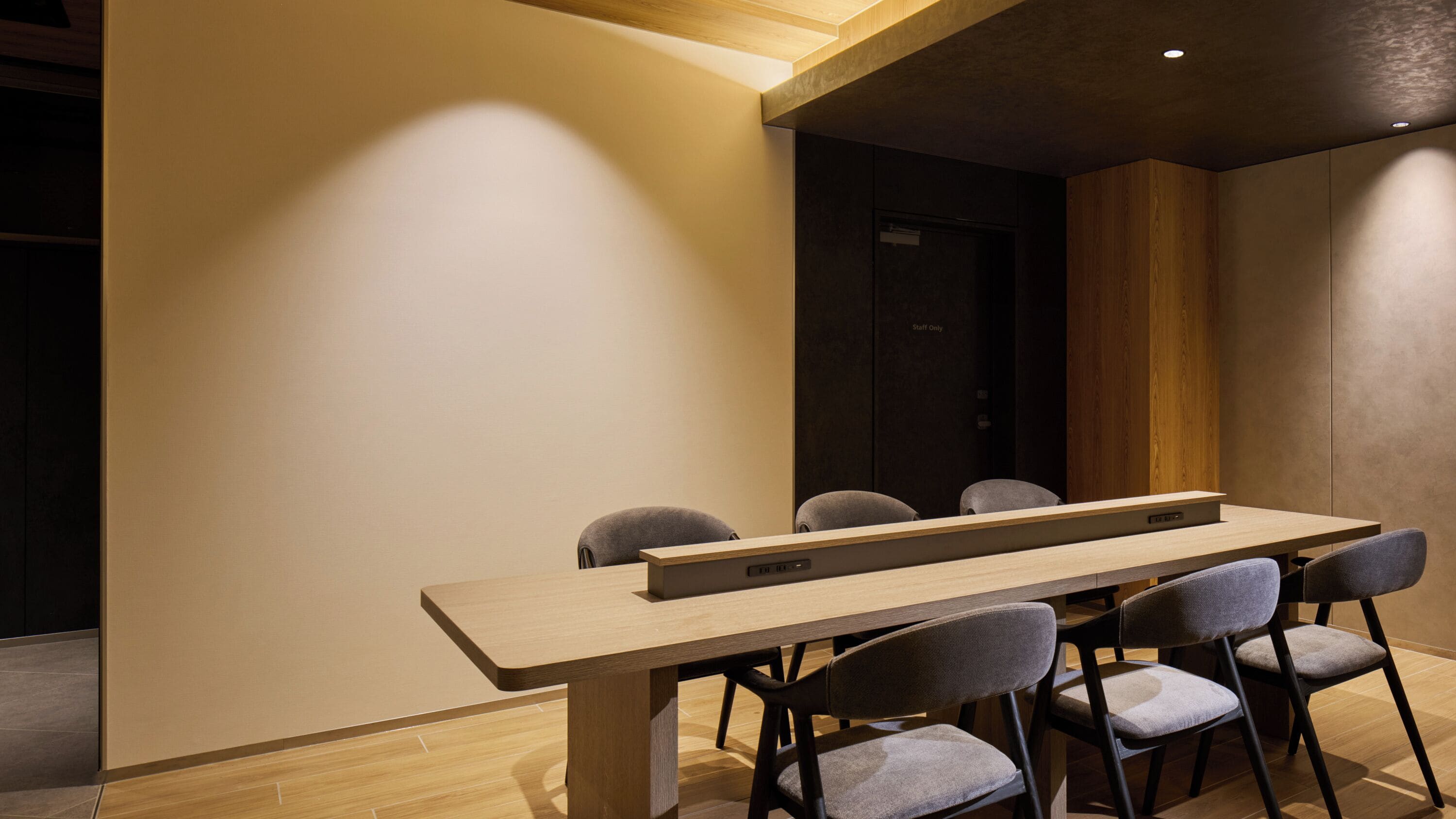 A conference room with a long table and six chairs.