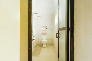 A small, clean bathroom with a toilet, sink, and shower. - Cozy Tanzania  (Dar es Salaam)