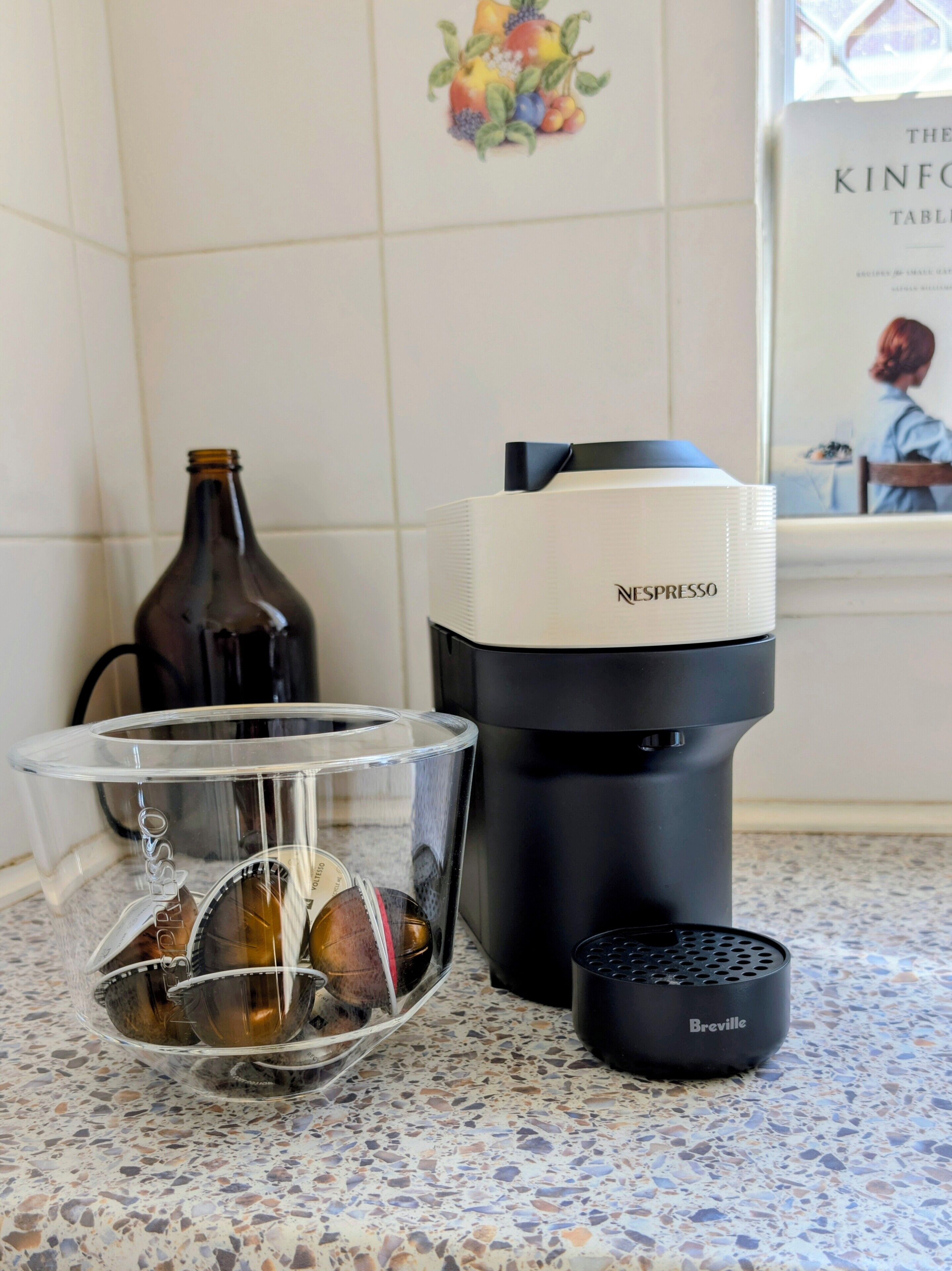 A coffee maker, a glass carafe, and a coffee pot on a kitchen counter.