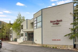 A modern building with a sign reading 'River Bank Lodge' and a 'No Parking Fire Lane' sign. - Perfect Keystone Ski Home: 2 Min Walk to Gondola! (Keystone)