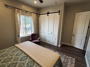 A bedroom with a bed, a chair, a wardrobe, and a window. - Fantastic 5-br, 3.5ba house with pool, hot tub AC located in Graham county, AZ. (Pima)