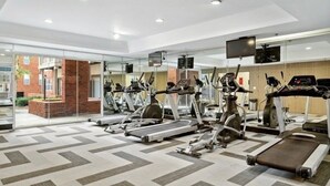 A gym with treadmills, stationary bikes, and elliptical machines. - Cozy Perimeter Unit with resort-style pool (Dunwoody)