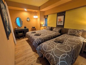 A hotel room with two beds, a desk, a mirror, and a wall-mounted artwork. - Private House for 17 Guests | 4 Apartments | Rooftop Garden | Dotonbori 5-Min (大阪市)