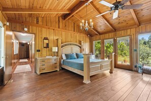 A wooden-paneled bedroom with a bed, dresser, and a ceiling fan. - Private Wine Country Escape With Sweeping Valley Views, Hot Tub, Apple Hill (Placerville)