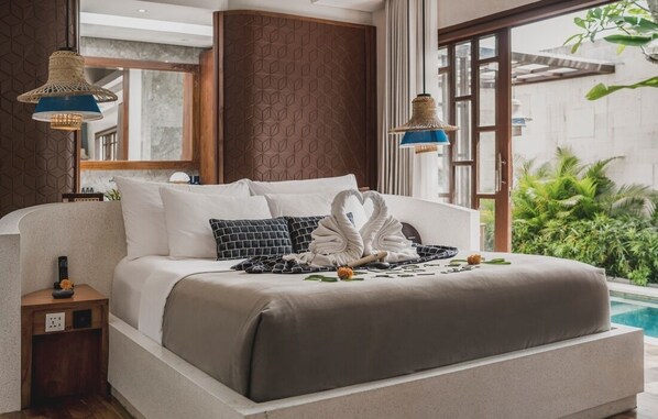 A modern hotel room with a large bed, a small bedside table, a nightstand, a large window, and a view of a swimming pool.