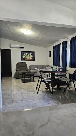 A living room with a sofa, armchairs, a dining table, and a ceiling fan. - "1200 m² Bacalar: Laguna a Pasos, Pet Friendly" (Xul-Ha)