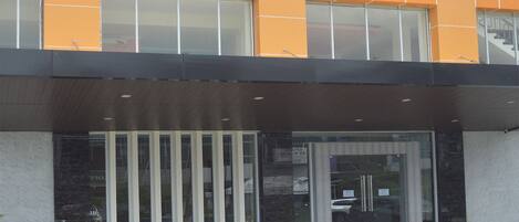 A modern building with large windows and a glass entrance.