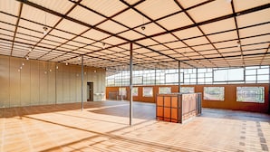 A spacious indoor area with a high ceiling, large windows, and a tiled floor. - Collection O Padang C Center Near Transmart Padang (Padang)