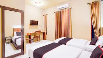 A hotel room with two beds, a desk, a chair, and a mirror.
