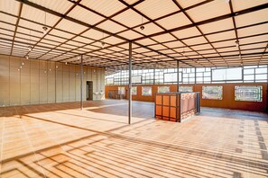 A spacious indoor area with a high ceiling, large windows, and a tiled floor. - Collection O Padang C Center Near Transmart Padang (Padang)