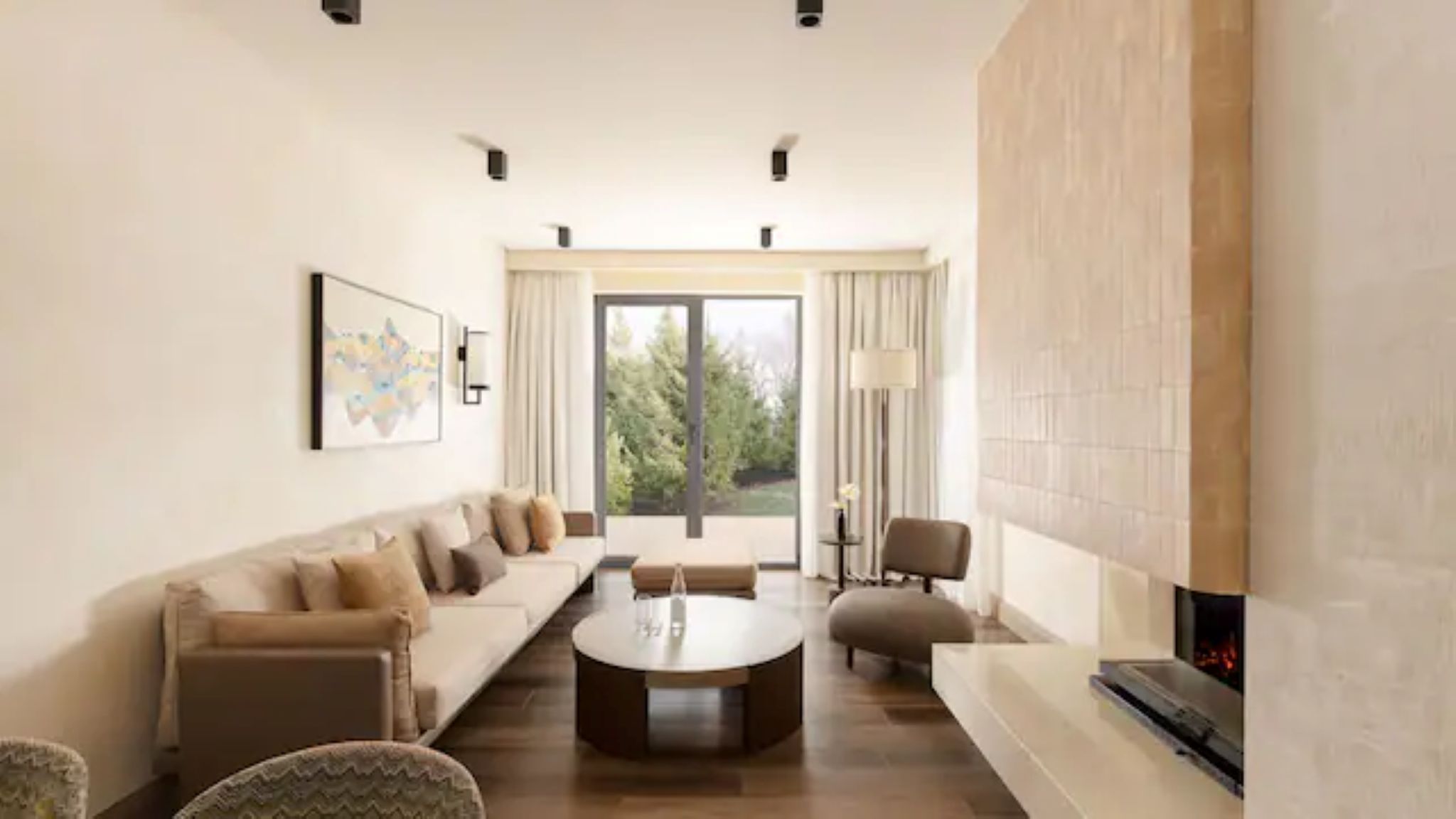 A modern living room with a sofa set, a coffee table, and a fireplace.