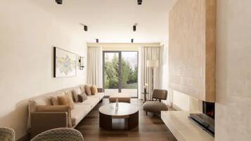 A modern living room with a sofa set, a coffee table, and a fireplace.