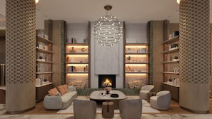 A modern living room with a fireplace, bookshelves, a sofa, and a coffee table.