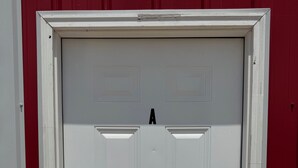 A white door with a letter 'A' above it, a keyhole on the right, and a red wall to the left. - Studio Suite Near Ouachita River & Hot Springs (Malvern)