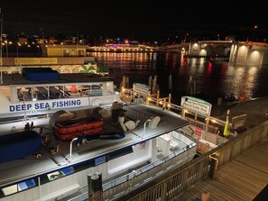 A boat named 'DEEP SEA FISHING' docked at a marina with a docked boat named 'CALYPSO BREEZE' in the background.