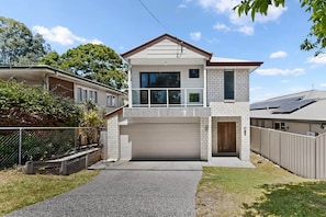 A two-story house with a garage, a balcony, and a fenced yard. - The Duncan Retreat Bald Hills QLD (Bald Hills)