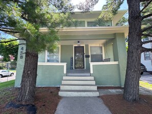 A two-story house with a front porch, a mailbox, and a door with a 'WELCOME' sign. - 3BR Family and Pet-Friendly College Hill Home • Walk to Wesley (Wichita)