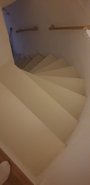 A staircase with a handrail and a white wall. - Typical Corsican village. (Sant’Antonino)