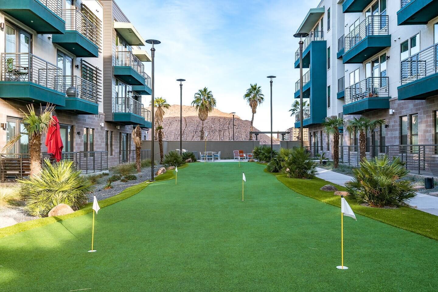 A golf course with a green fairway, sand bunkers, and a flagstick.