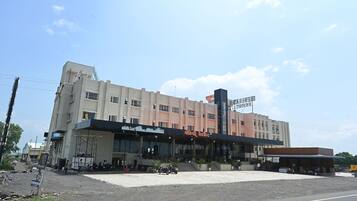 A multi-story building with a flat facade, large windows, and a sign indicating it is a hotel.
