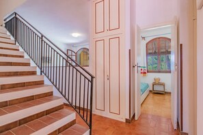 A staircase with a metal railing, a set of double doors, and a window with a view of greenery outside. - Villa Valentina - Villa Valentina 1 (Capoliveri)