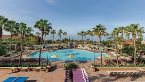 A resort pool area with multiple pools, palm trees, and lounge chairs. - 2-bedroom resort in gorgeous Newport Beach with fitness room and AC (Newport Beach)