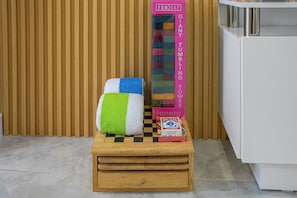 A checkered wooden stool with a colorful towel and a giant tumbling toy box. - Adorable 2-bedroom house next to Hard Rock Casino (Fort Lauderdale)