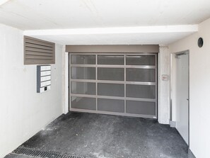 A closed metal gate with a security keypad and a small vent above it. - Modern holiday apartment with terrace in Jenbach (Jenbach)