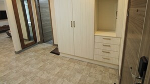 A room with a wardrobe, a mirror, and a door. - La Grande Residence - Deluxe Suite A (Angeles)