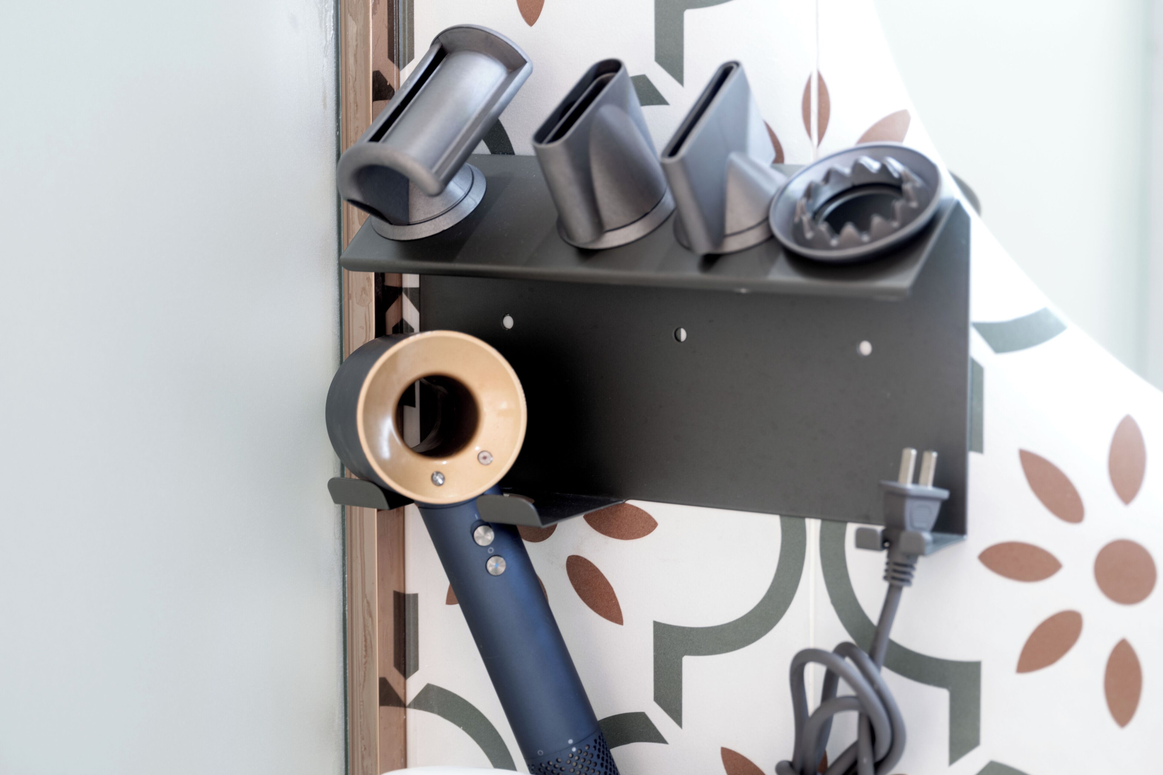 A wall-mounted charging station with multiple plugs and a power cord.