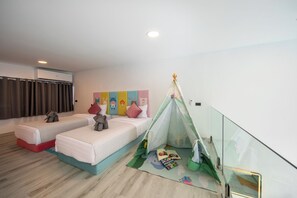 A hotel room with two beds, a children's play area, and a glass railing. - Pool Access Large Townhouse (Koh Samui)