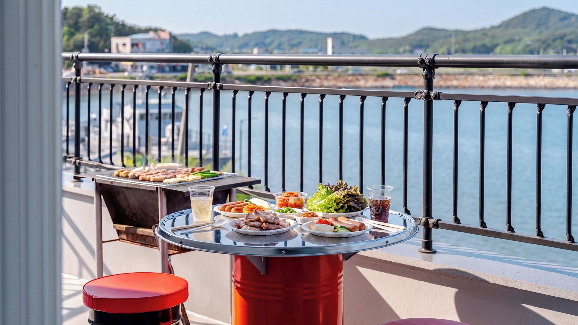 A balcony with a grill, dining table, and various dishes.