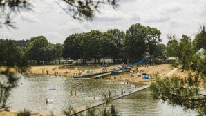 A water park with a sandy beach, a water slide, and a pond. - Holiday Home in Wilsum With Hottub (Wilsum)