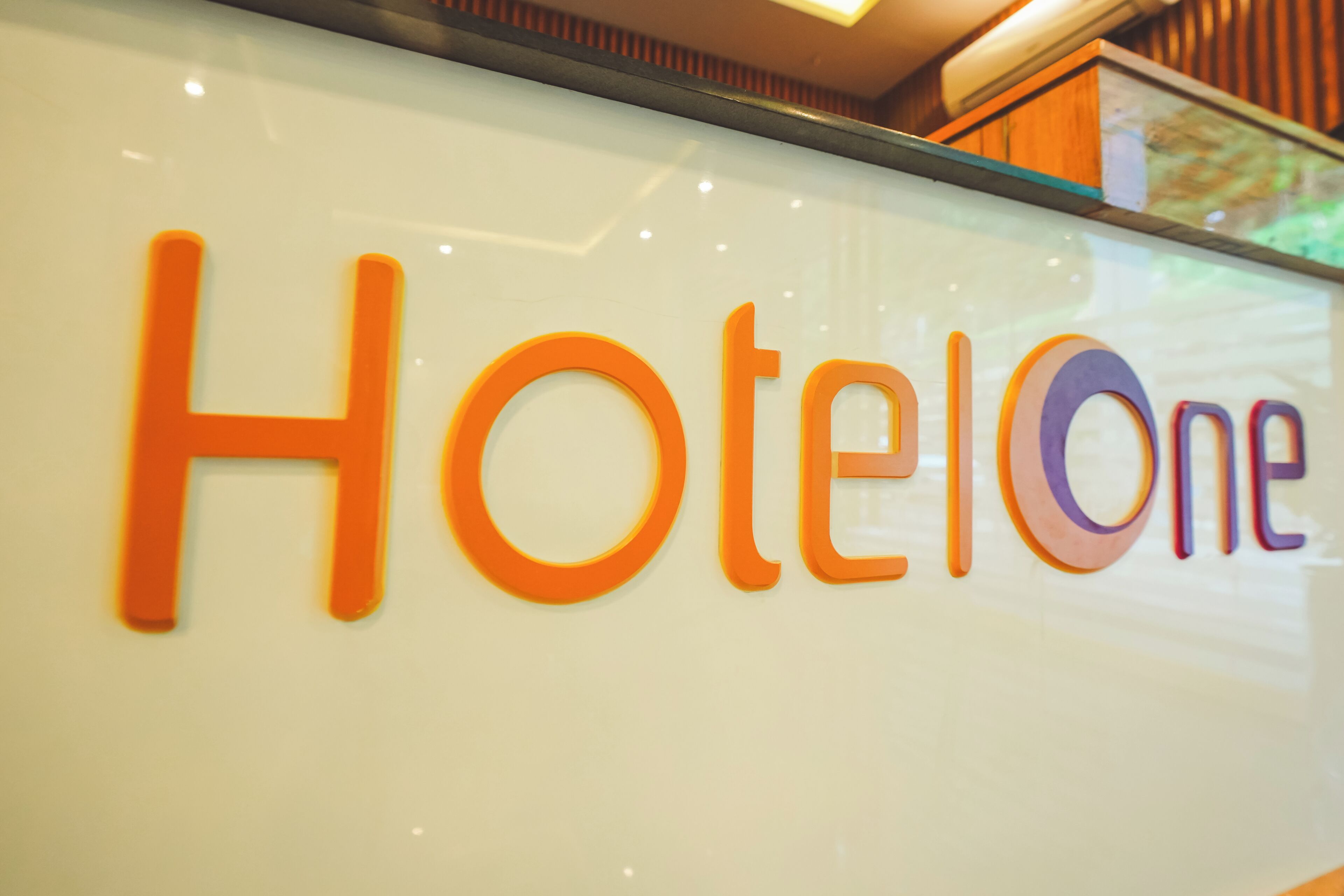A sign with the text 'HotelOne' in large, colorful letters.