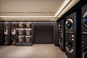A laundry room with multiple washing machines, a drying machine, and neatly arranged laundry bags on shelves. - Intercity Hotel Chengdu High tech Center (Chengdu)