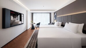 A hotel room with two beds, a TV mounted on the wall, a small table with a chair, and a large window with curtains. - Intercity Hotel Chengdu High tech Center (Chengdu)