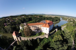 A castle-like building with a moat, surrounded by greenery and a river. - 3BR Country House with Pool & WiFi (Ribnik)