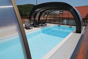 A swimming pool with lounge chairs and a covered area. - 3BR Country House with Pool & WiFi (Ribnik)