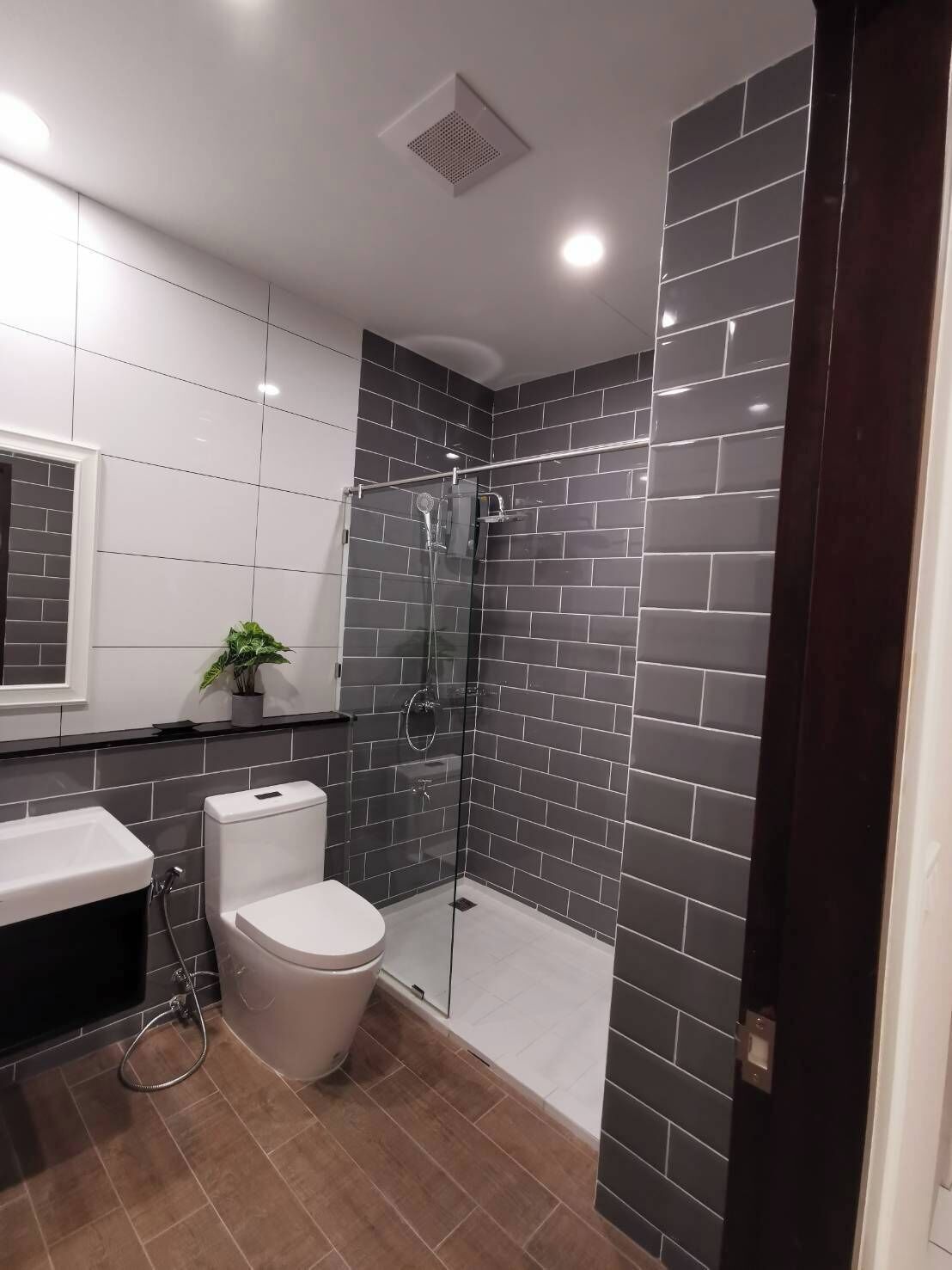 Une salle de bain moderne avec une douche à parois de verre, des toilettes et un lavabo.