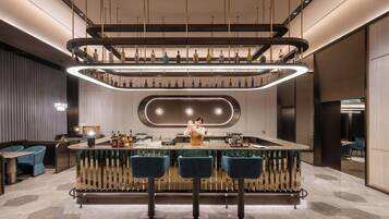 A modern bar area with a central bar counter, three bar stools, and a bartender.