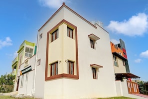 A modern building with a sign reading 'KAYILAH RESIDENCY.'
