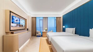 A hotel room with a TV, two beds, a desk, and a view of the city. - Crystal Hotel Qingdao Hi-Tech Convention (Qingdao)