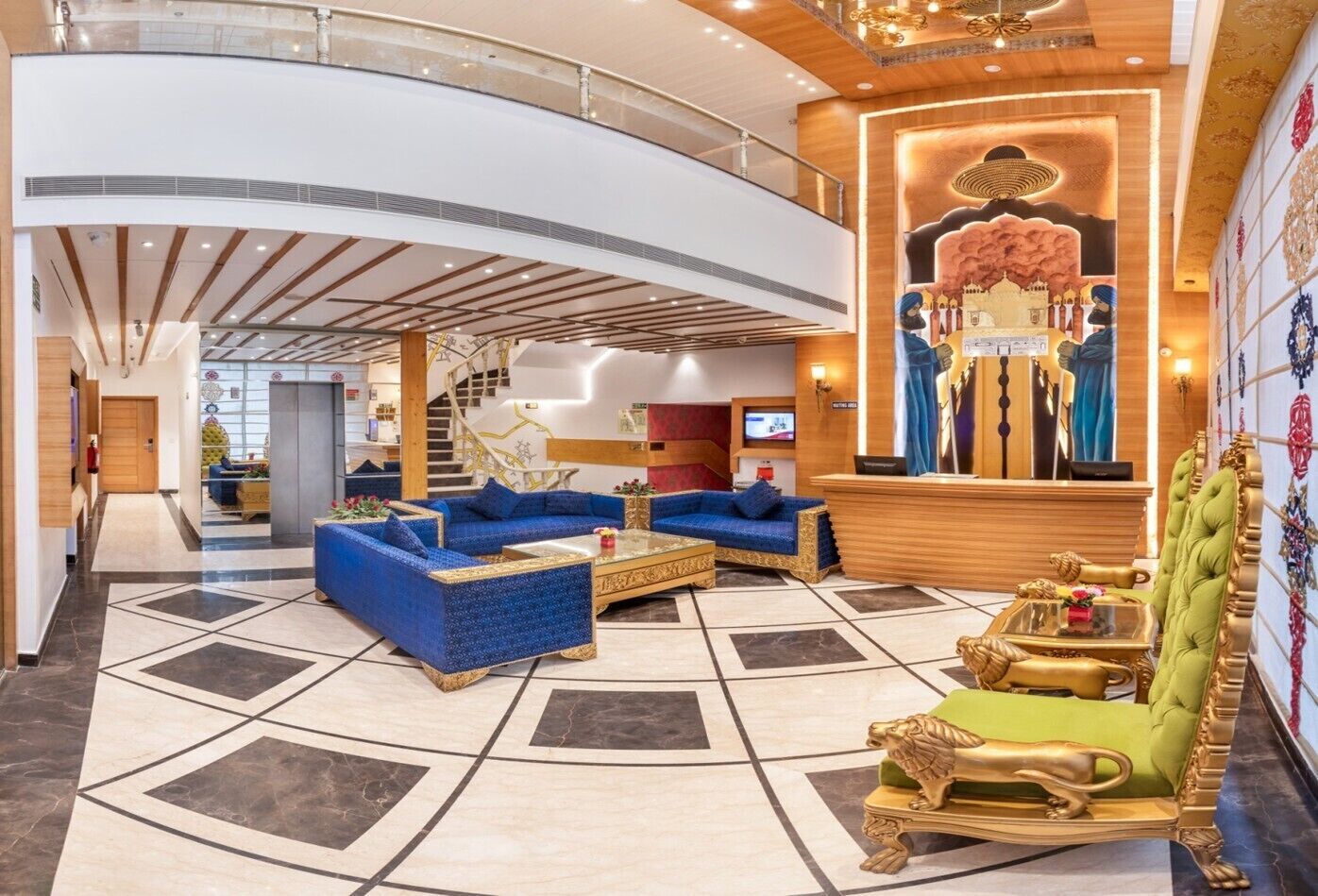A spacious lobby with a curved ceiling, a reception desk, and a staircase.