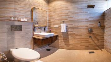 A modern bathroom with a wooden wall design, a white sink, a mirror, and a shower area.