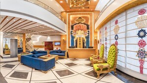 A lobby with a reception desk, seating area, and a decorative wall with patterned tiles. - Lords Inn Amritsar (Amritsar)