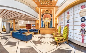 A lobby with a reception desk, seating area, and a decorative wall with patterned tiles. - Lords Inn Amritsar (Amritsar)