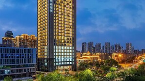 A high-rise hotel with a modern design, featuring numerous windows and a prominent entrance.